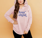 woman wearing blush colored hoodie with blue "flour child" text